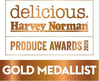 A logo in a metallic bronze finish reads: Delicious and Harvey Norman Produce Awards 2020 - Gold Medallist
